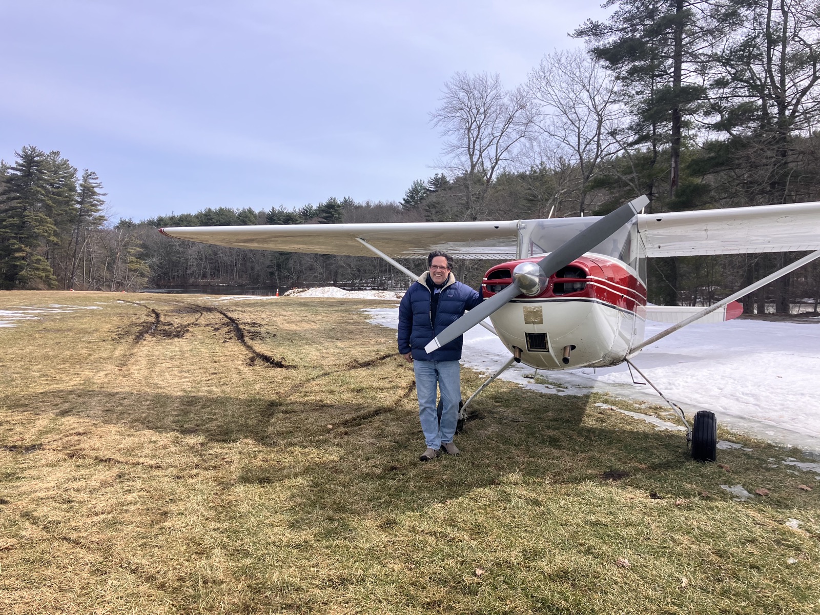Nick standing with Cessna 170B N72C after extracting it from a muddy rut at Crow Island